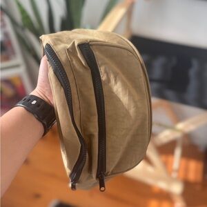 Elegant Tan Crossbody Bag with Black Zippers